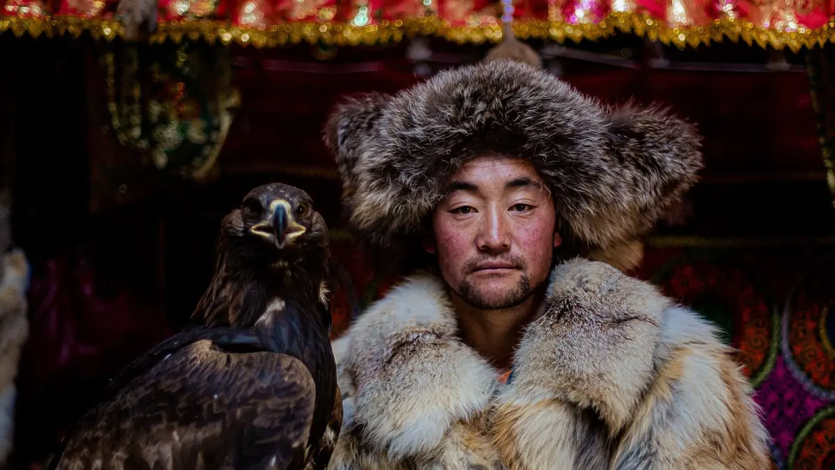An eagle hunter with his golden eagle, western Mongolia