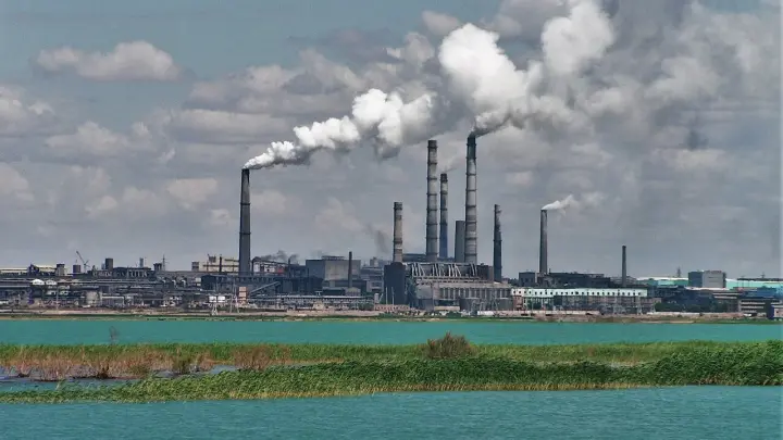 Copper smelting plant in Balkhash: factory chimneys on the lake shore